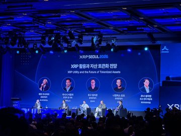 Image 2: A panel discussion at the XRP Seoul 2025 event, with on-screen text in Korean reading "XRP Utility and the Future of Tokenized Assets" and "XRP 통합과 자산 토큰화의 전망", featuring five speakers seated on stage.