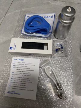 A packaged HKT 128 type radiation survey meter set laid out on bubble wrap, including a metal probe, blue resistance band, lanyard, and instruction sheet.