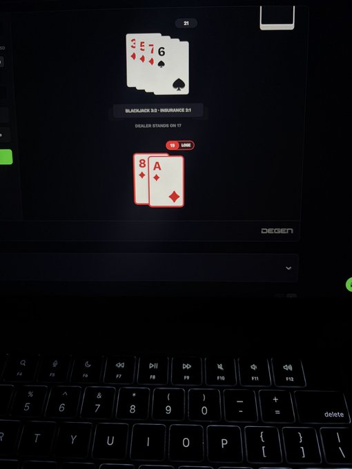 Photo of a laptop displaying a digital blackjack game where the dealer has a 6 and the player has an 8 and Ace, showing an "INSURANCE" prompt for $1 with a balance of $1,466, branded "DEGEN".