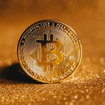 The image features a close-up view of a gold coin with the word "bitcoin" written on it. The coin has a shiny appearance due to its metallic sheen, and it appears to be sitting on a surface that looks like sand or dirt. The background is blurred, drawing attention to the coin as the main subject of the image.

The post discussing Bitcoin and gold coins mentions that central bank reserves are shifting towards these digital assets, which could potentially impact traditional currency systems. This shift may lead to changes in how people perceive and use money, with a growing interest in alternative forms of currency like Bitcoin. The post also highlights the increasing popularity of Bitcoin as an investment option due to its potential for high returns and decentralization.