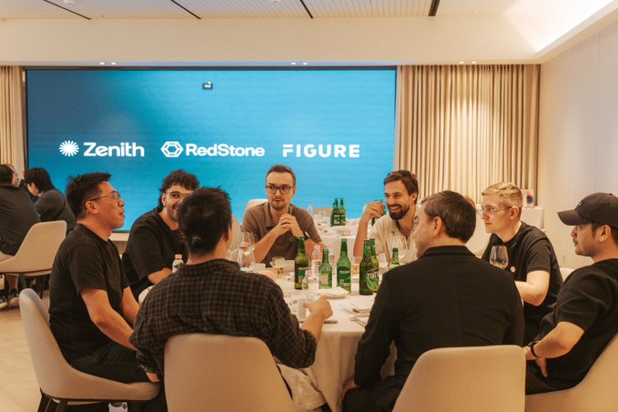 A group of men seated around a dining table in a conference room with a screen displaying 'Zenith', 'RedStone', and 'FIGURE' logos.