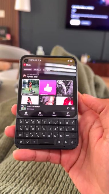 A close-up shows a hand holding a smartphone displaying YouTube Music with the song "LOST YO MIND" by Beyoncé, and a "Speed dial" podcast shortcut visible. The image relates to the post's reference to "BB" as a stock ticker by visually highlighting the "BB" initials in the song/artist branding, suggesting it as a creative tie-in to the question about BlackBerry's stock rising.