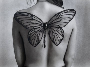 A black and white photograph showing the back of a person with large butterfly wings seemingly tattooed or applied across their shoulder blades.