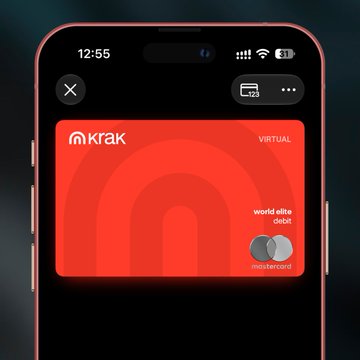 A smartphone screen displaying a red Krak virtual debit Mastercard with the text 'world elite debit' and the Mastercard logo.
