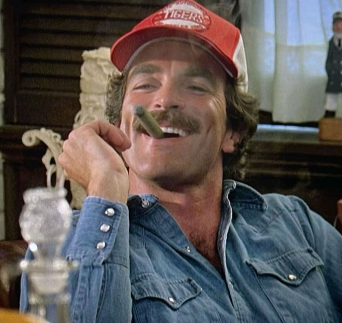A man wearing a red and white "Tigers" baseball cap and a denim shirt smiles broadly while holding a lit cigar. The image humorously reinforces the post's triumphant mood, echoing the famous "Feels Good Man" meme typically used to express satisfaction after a successful outcome like selling three valuable 1/1 items.