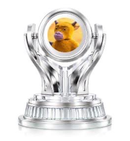 A silver trophy featuring a small figure with an animal face inside a central sphere.