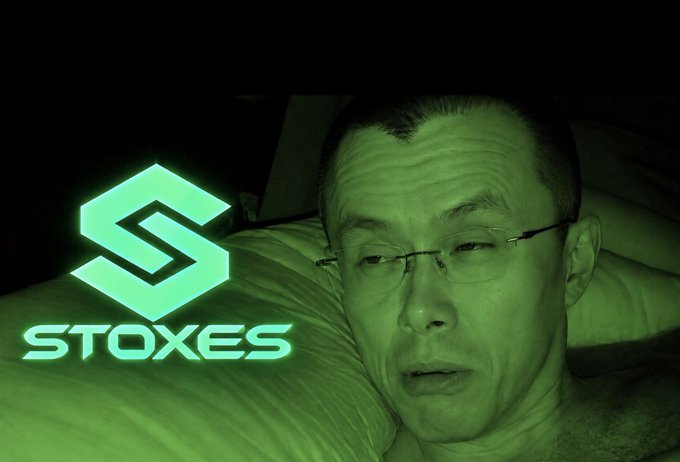 A green-tinted image of a man wearing glasses lying down, with the "STOXES" logo featuring a stylized 'S' prominently displayed on the left.