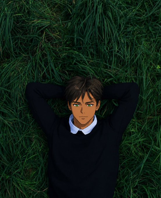 An anime-style illustration of a young man with dark hair, tan skin, and green eyes lying on his back in lush green grass with his hands behind his head, wearing a black sweater over a white collared shirt.