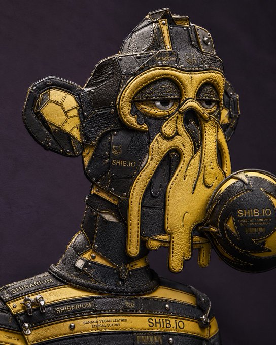 A stylized character resembling an armored figure with octopus-like tentacles, wearing a black and gold helmet and holding a ball branded "SHIB.IO," with "SHIBARIUM" and "BANANA VEGAN LEATHER ETHICAL LUXURY" labels visible on its collar. The image ties into the post's theme of disciplined trading by personifying the "controlled risk" philosophy through a battle-ready Shiba Inu-inspired mascot, reinforcing Shib.io's branding around strategy, probability, and calculated decision-making.