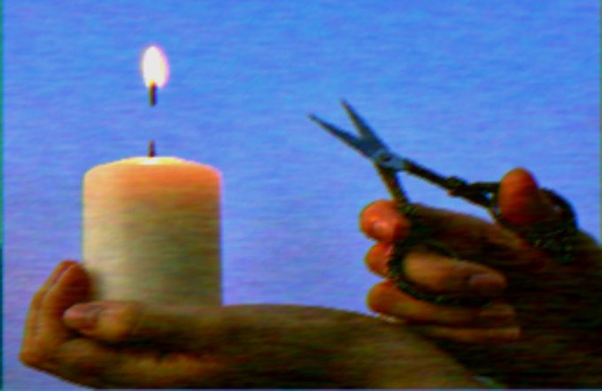 Hands holding a lit white candle on the left and ornate scissors on the right, set against a blue gradient background.