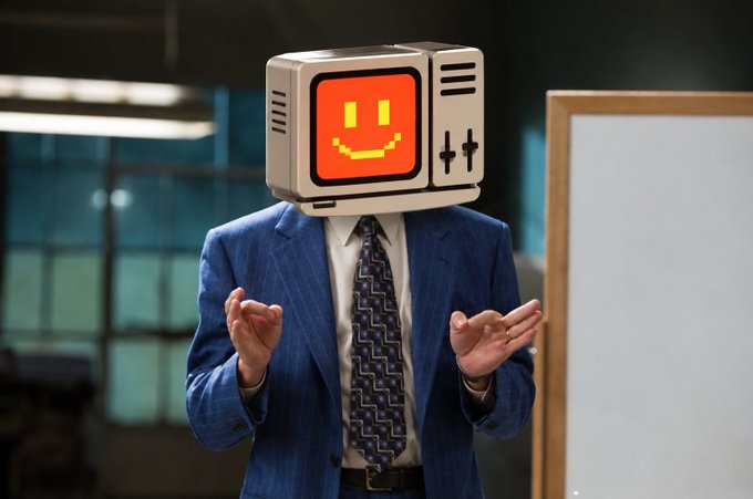 A surreal image of a person in a blue suit and patterned tie with a retro orange smiley-face computer monitor as their head, standing in an office setting.