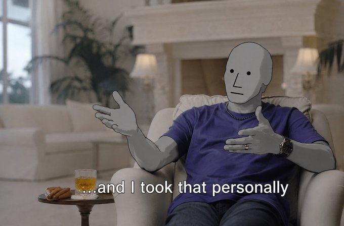 An edited image shows a man in a purple t-shirt wearing a white featureless mask, sitting in a luxurious living room with the caption '...and I took that personally'.