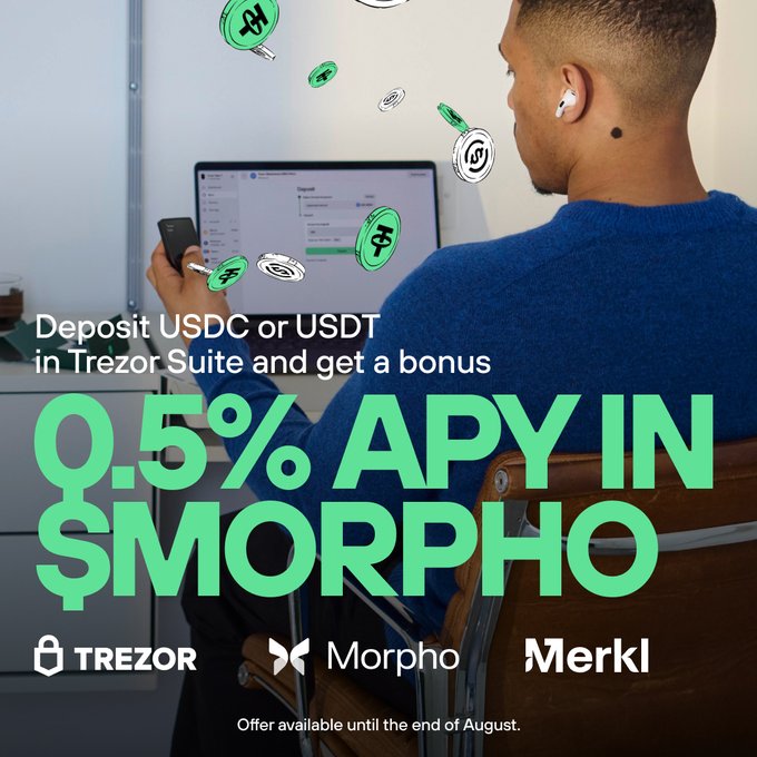 A man in a blue sweater uses a laptop with wireless earbuds, surrounded by floating animated MORPHO and USDC/USDT coin graphics, promoting Trezor's campaign offering 0.5% APY in $MORPHO tokens for depositing $USDC or $USDT in Trezor Suite via Merkl-powered Earn tab, with logos for Trezor, Morpho, and Merkl displayed.