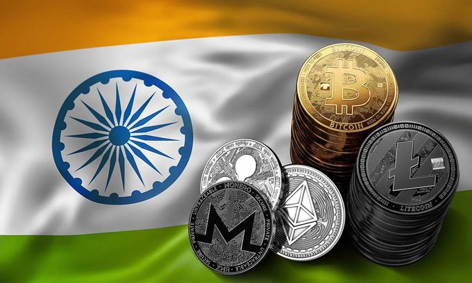 Physical cryptocurrency coins—including Bitcoin, Litecoin, Monero, and Ethereum—rest atop the Indian flag, symbolizing the nation's dominance in crypto derivatives trading, where over 80% of volume is now in futures due to a 1% TDS on spot trades.