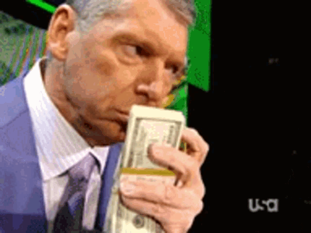 A man in a blue suit bites down on a stack of banded cash bills, with the USA network logo visible in the corner. The image humorously illustrates the post's point about how easily verified users (big Vs) can make money through donation drives on X (Twitter).