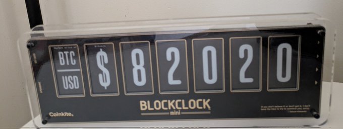A Coinkite Blockclock Mini displaying the BTC/USD price as $82020.