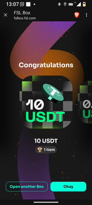 The image shows a phone screen displaying a message congratulating someone for winning 10 USDT coins. The text "Congratulations" is written above the number 10, indicating that the person has won ten USDT tokens. The phone's screen also displays an open box with a green and purple background, which could be related to the gaming or cryptocurrency world.