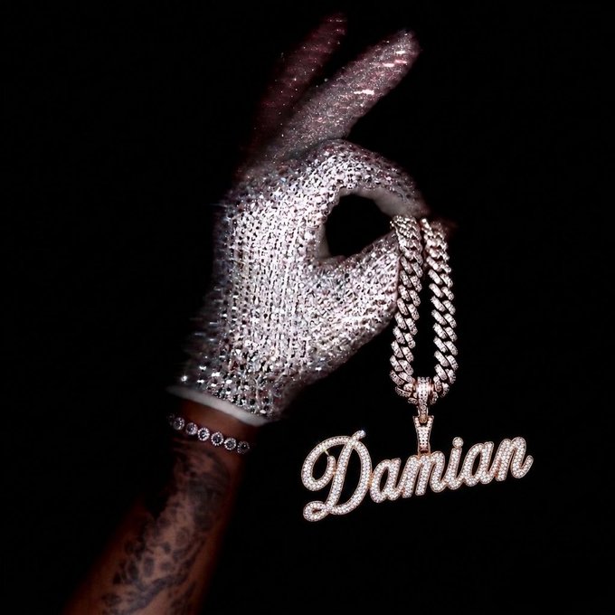 𝕏 is written on a pendant that is attached to a chain.