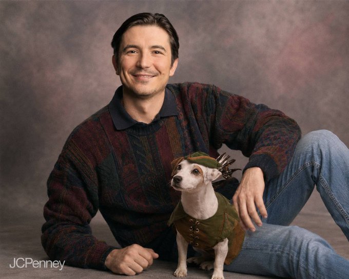 A JCPenney advertisement shows a smiling man in a patterned sweater sitting with a small dog dressed in a green hunting outfit with a cap and what appears to be arrows on its back.