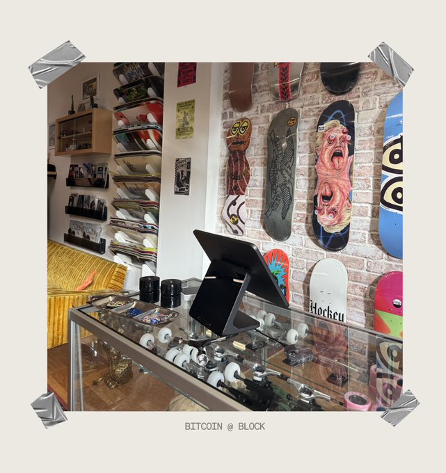 A collage-taped photo of a skate shop's interior, featuring walls lined with colorful skateboard decks—including designs with screaming faces, spirals, and "Hockey" branding—alongside a glass display case holding wheels and a tablet. Caption: "Nice day on the block" ties in with the "BITCOIN @ BLOCK" tagline at the bottom, blending skate culture aesthetics with crypto branding.