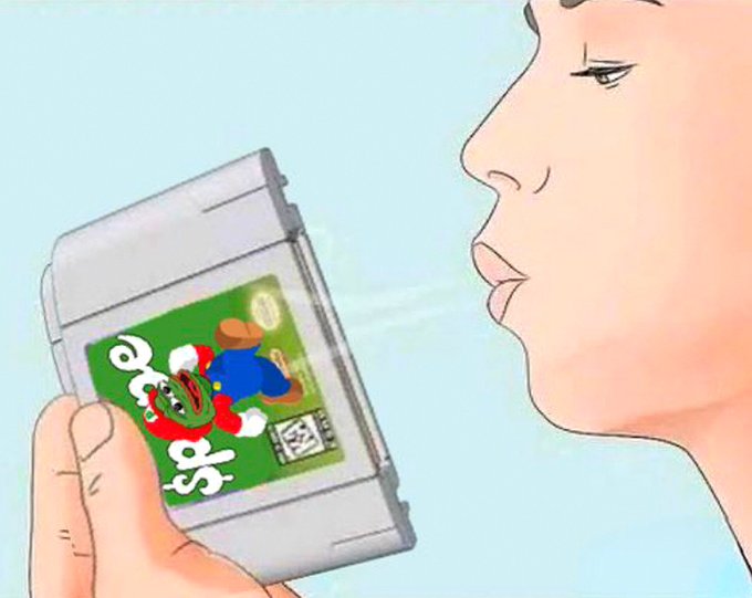 An anime-style illustration depicts a person holding a grey cartridge labeled 'Smaho' featuring a green cartoon character in a red and blue outfit.