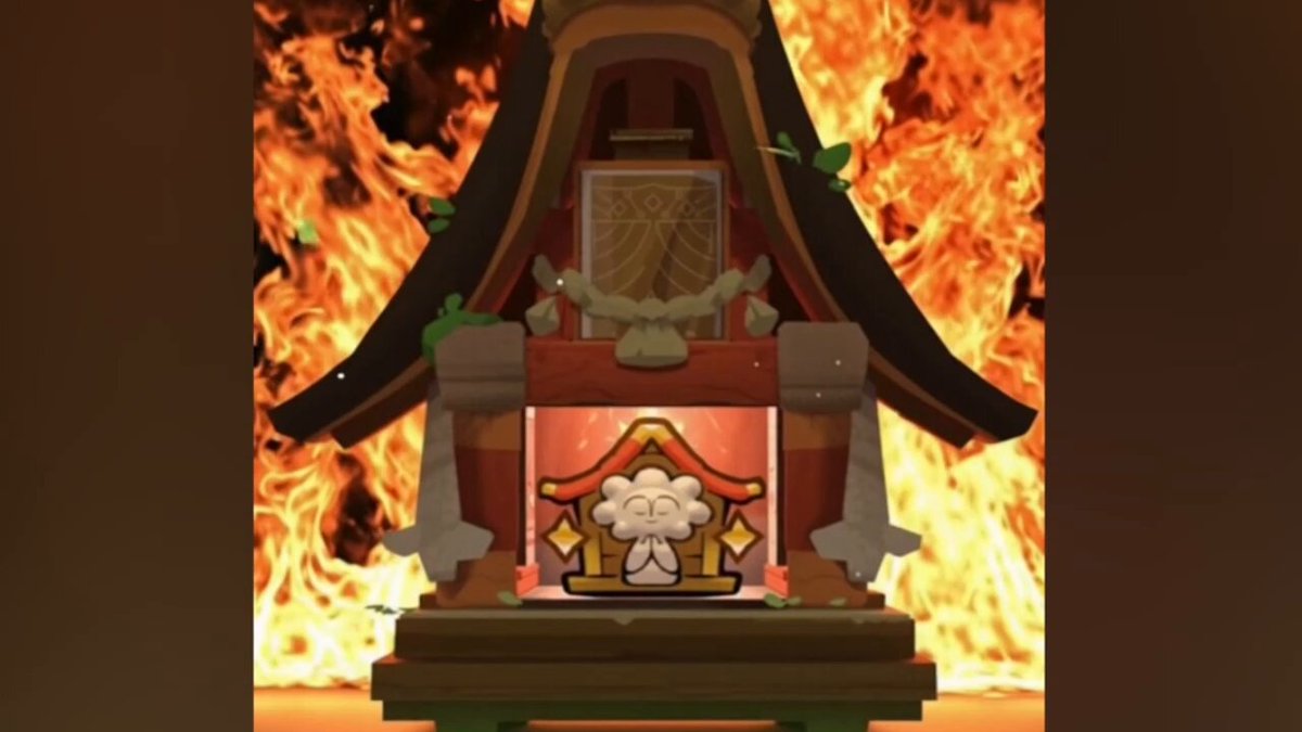 The image features a shrine with a small white figure inside, surrounded by flames. The shrine has a red roof and a wooden structure, giving it an old-fashioned appearance. The fire appears to be burning brightly behind the shrine, creating a dramatic effect in the scene. The caption of the post reads "My Three Awesome Years Of Praying Atia'S Blessing! Deserve a Badge? @AxieInfinity @Ronin_Network #axie #Music #Praying #Education #Web3 #Gaming #NFT #Crypto #Dedication #Devotion". The image is related to the post because it showcases an old-fashioned shrine with a white figure inside, which could be considered a shrine dedicated to Atia.