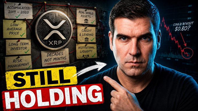 A YouTube thumbnail featuring a man pointing at text reading 'STILL HOLDING' alongside XRP cryptocurrency branding, mentions of 'REAL WORLD ASSETS', 'DECADES NOT MONTHS', and a 'COULD REVISIT $0.80?' price target.