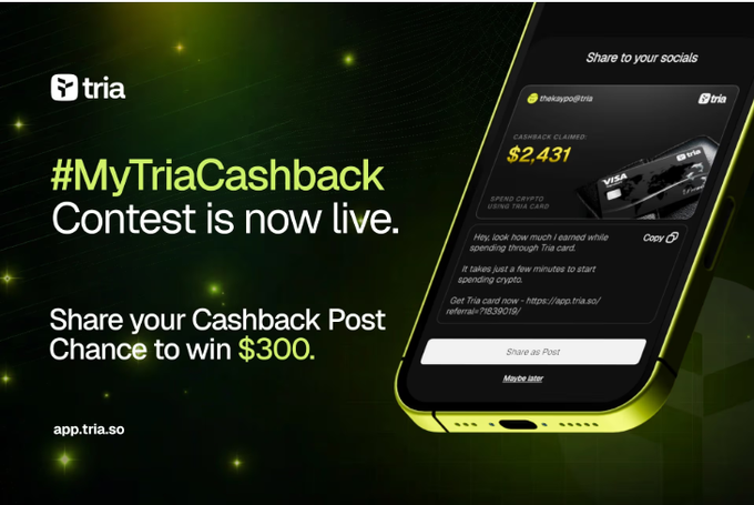 The image shows a phone screen with an advertisement for a contest, specifically a MyTria Cashback contest. The phone displays the text "MyTria Cashback Contest is now live." This indicates that the contest has been officially launched and participants are encouraged to enter by sharing their cashback posts on social media using the provided hashtag. The image also includes a link to the contest page, where users can learn more about the contest and how to participate.
