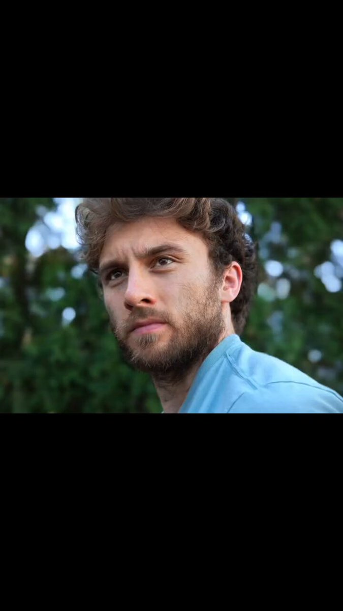 The image features a man wearing a blue shirt, standing against a black background. He has a beard and appears to be looking off into the distance or deep thought. The photo seems to have been taken by someone named Degen, who has posted it on social media with the caption "Degens trying to figure out what to do with their ETH bags right now".