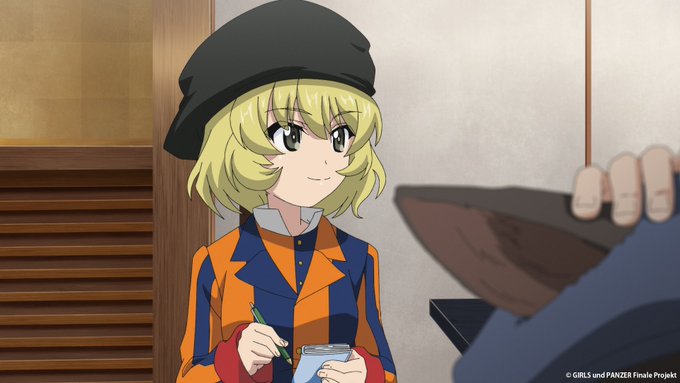 An anime scene featuring a blonde character in a black hat and orange checkered jacket holding a pen and cup, from 'Girls und Panzer Finale Project'.