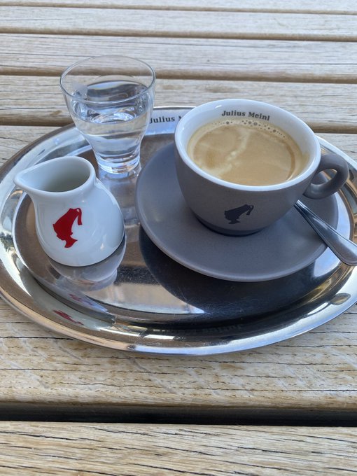 A coffee from Julius Meinl featuring a small cream pitcher with a red bull logo accompanies the caption "Gm Bulls," visually echoing the "bulls" reference in the post.