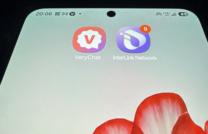 The image shows a smartphone home screen displaying two app icons: "VeryChat" and "InterLink Network," the latter with a notification badge showing 9 unread alerts. The post references a "Best KYC validation" discussion, suggesting both VeryChat and InterLink Network are being compared for their KYC (Know Your Customer) verification credentials.