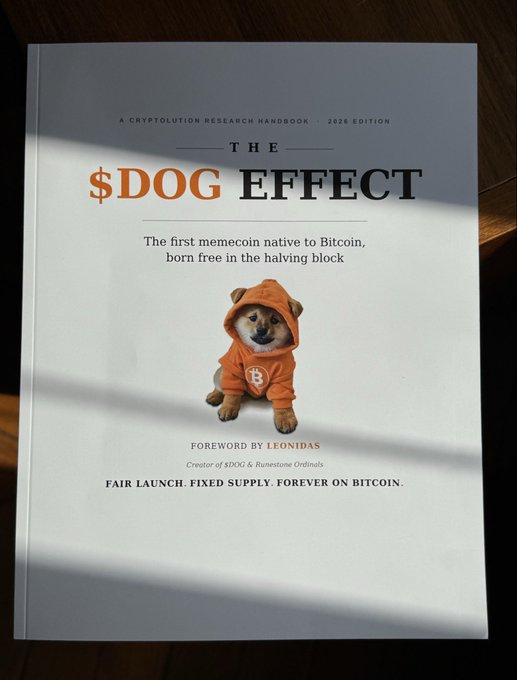 A book cover titled '$DOG EFFECT' featuring a dog in an orange hoodie, described as 'A Cryptolution Research Handbook, 2026 Edition' and 'The first memecoin native to Bitcoin, born free in the halving block,' with a foreword by Leonidas.