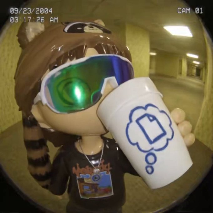 A security camera timestamped 09/23/2004 03:17:26 AM, CAM 01, showing a figurine wearing green ski goggles holding a white cup with a thought bubble containing a rectangle.