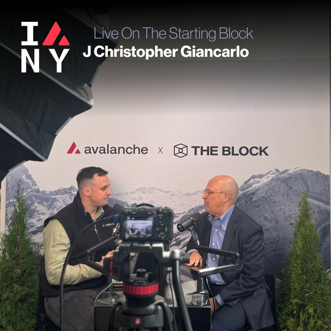 Two men are seated in a podcast-style interview setup with a mountain backdrop, featuring text overlays reading "IANY Live On The Starting Block J Christopher Giancarlo," along with logos for "Avalanche" and "THE BLOCK." The image relates to the post by showing J. Christopher Giancarlo, former CFTC Chair, appearing as a guest on The Starting Block to discuss "The Clarity Act impasse."