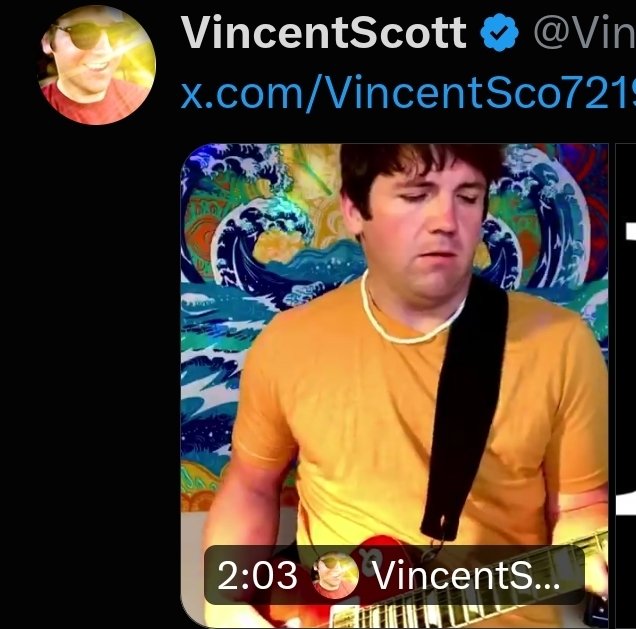 A Twitter/X post by verified user @VincentSco72192 ("VincentScott") featuring a 2:03 video thumbnail of a man with a guitar strap, wearing an orange shirt and a beaded necklace, posed against a Van Gogh "Starry Night"-style wave backdrop with an astrology "Capricorn" emoji ♑ overlaying the image. The accompanying caption links the figure to Tucker Carlson's foray into cryptocurrency.