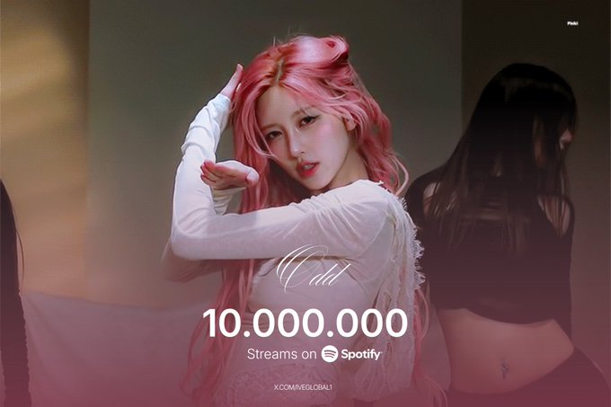 A woman with long pink hair poses in a white top with her arm raised, with text reading 'On My 10,000,000 Streams on Spotify' and 'X.COM/VEGLOBAL1'.