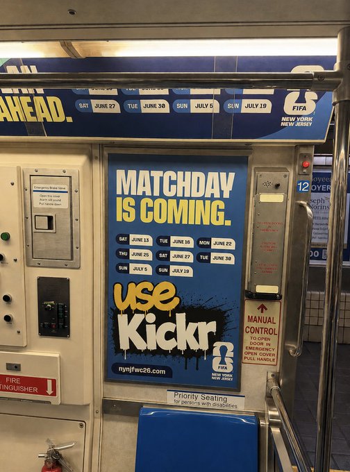The image shows a subway car with an advertisement for kickdrag. The advertisement features a blue sign that reads "matchday is coming" along with a picture of a soccer ball. There are also instructions written below the advertisement, which include directions on how to use the kickdrag and where to find it.