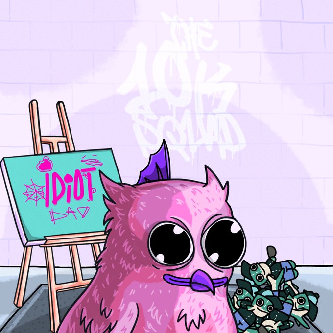 A cartoon illustration of a pink owl-like creature with large eyes holding a small dragon, standing near an easel displaying "IDIOT DAD" graffiti, with "THE IDIOT SQUAD" tagged on the wall behind.
