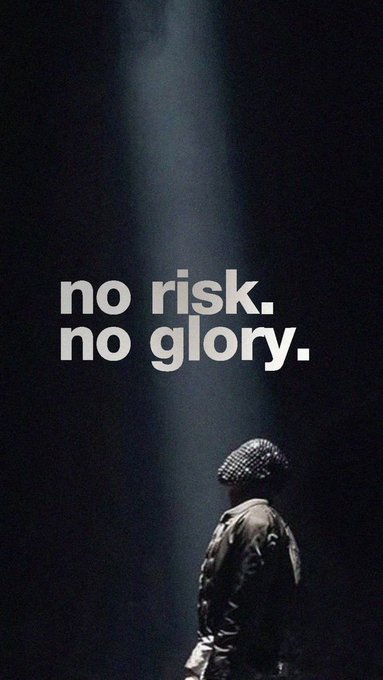 A dark motivational poster showing a silhouetted figure with a spotlight, featuring the bold white text 'no risk. no glory.'