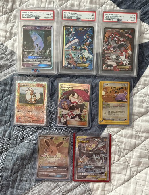 Eight Pokemon trading cards are displayed on a gray quilted fabric, including PSA-graded hits like a 2017 Sun & Moon Mewtwo GX #162 (Mint 9), 2015 XY Aqua & Holon Gyarados EX #30, 2015 XY Ancient Origins Groudon EX #44, plus ungraded cards such as the featured "Ditto" card (visible on the right) and Jessie & James trainer card, aligning with the post celebrating a recent Ditto sale.