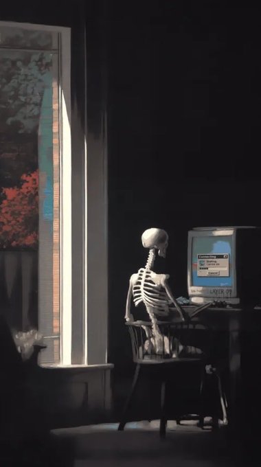 A skeleton sits at a desk in a dark room facing a vintage computer monitor, illuminated by a narrow beam of light from an adjacent window with stained glass.