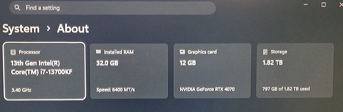 A Windows 'System > About' settings screen displaying specs: '13th Gen Intel Core i7-13700KF' Processor at 3.40 GHz, 32.0 GB Installed RAM, NVIDIA GeForce RTX 4070 graphics card, and 1.82 TB Storage.