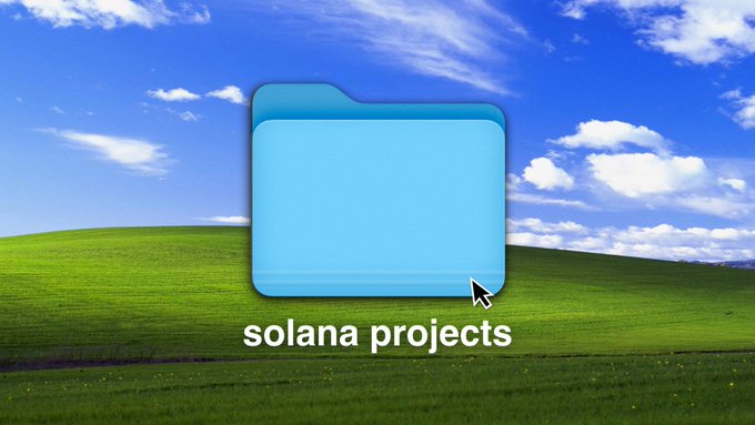A blue computer folder icon with a cursor arrow, overlaid on the classic Windows XP 'Bliss' green hills wallpaper, with the text 'solana projects' below.