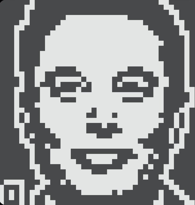 A grayscale pixel art portrait depicting a smiling person with a hood or head covering.