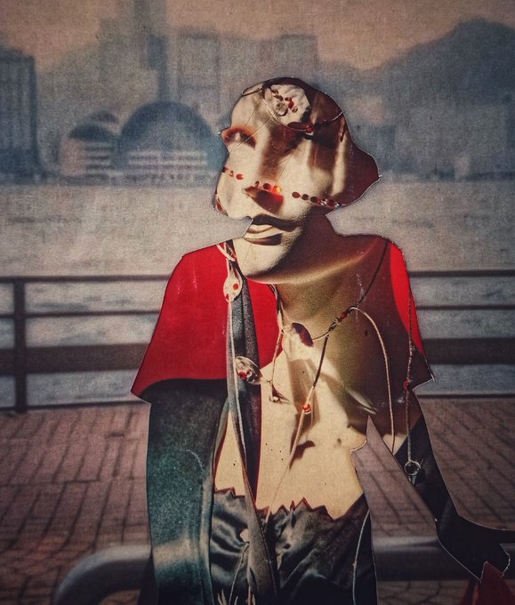 An abstract portrait of a figure with a distorted face wearing a red cape-like garment, set against a hazy urban backdrop.
