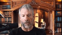The image shows a man with gray hair wearing a black shirt, standing in front of a bookshelf filled with numerous books. The man appears to be talking into a microphone during an online meeting or presentation. The caption above the image reads "lol Saylor & @Strategy selling is good or bad for $BTC". This suggests that the man might be discussing the value and impact of certain strategies, such as those related to bookselling, in relation to Bitcoin.