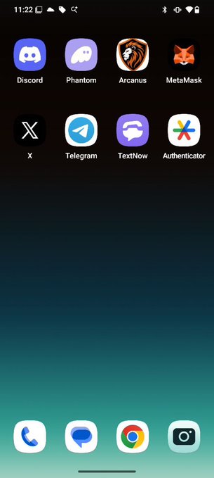 A smartphone home screen displaying apps including Discord, Phantom, Arcanus, MetaMask, X, Telegram, TextNow, and Authenticator, with Phone, Messages, Chrome, and Camera in the dock.