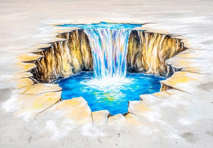 A 3D anamorphic drawing of a waterfall cascading into a blue pool, creating the illusion of a crater in a flat surface.