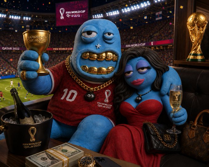 The image features a man wearing a red shirt holding a gold trophy, with a woman sitting next to him. The scene takes place at a soccer stadium, where there are several other people present as well. A wine glass can be seen on a table in front of them, and a handbag is placed nearby. The overall atmosphere suggests that the image might be related to an advertisement or promotional material for a sports event or a similar gathering.